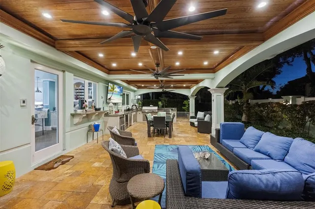 a living room with furniture a ceiling fan and a rug