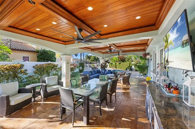 a view of a patio with table and chairs and potted plants