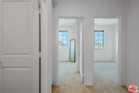 an empty room that has a wooden cupboard