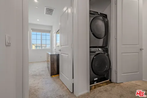 a view of a storage and utility room with washer and dryer
