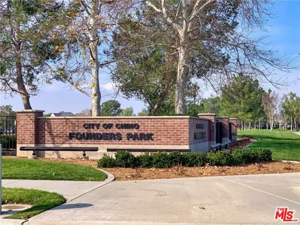 a view of a water fountain and a bench