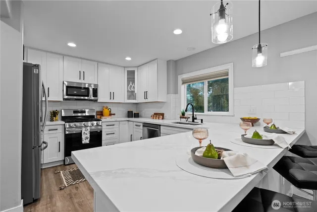 a kitchen with sink refrigerator and microwave