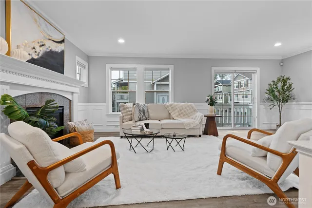 a living room with furniture a fireplace and a potted plant