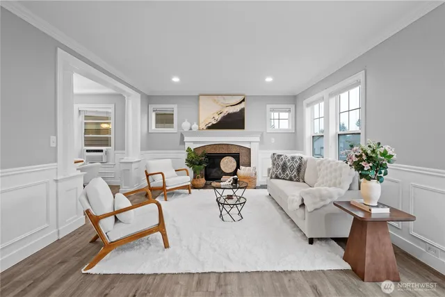 a living room with furniture fireplace and window