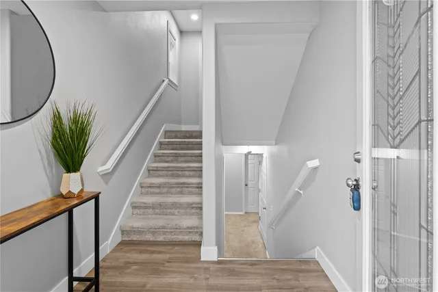a view of entryway and hall with wooden floor
