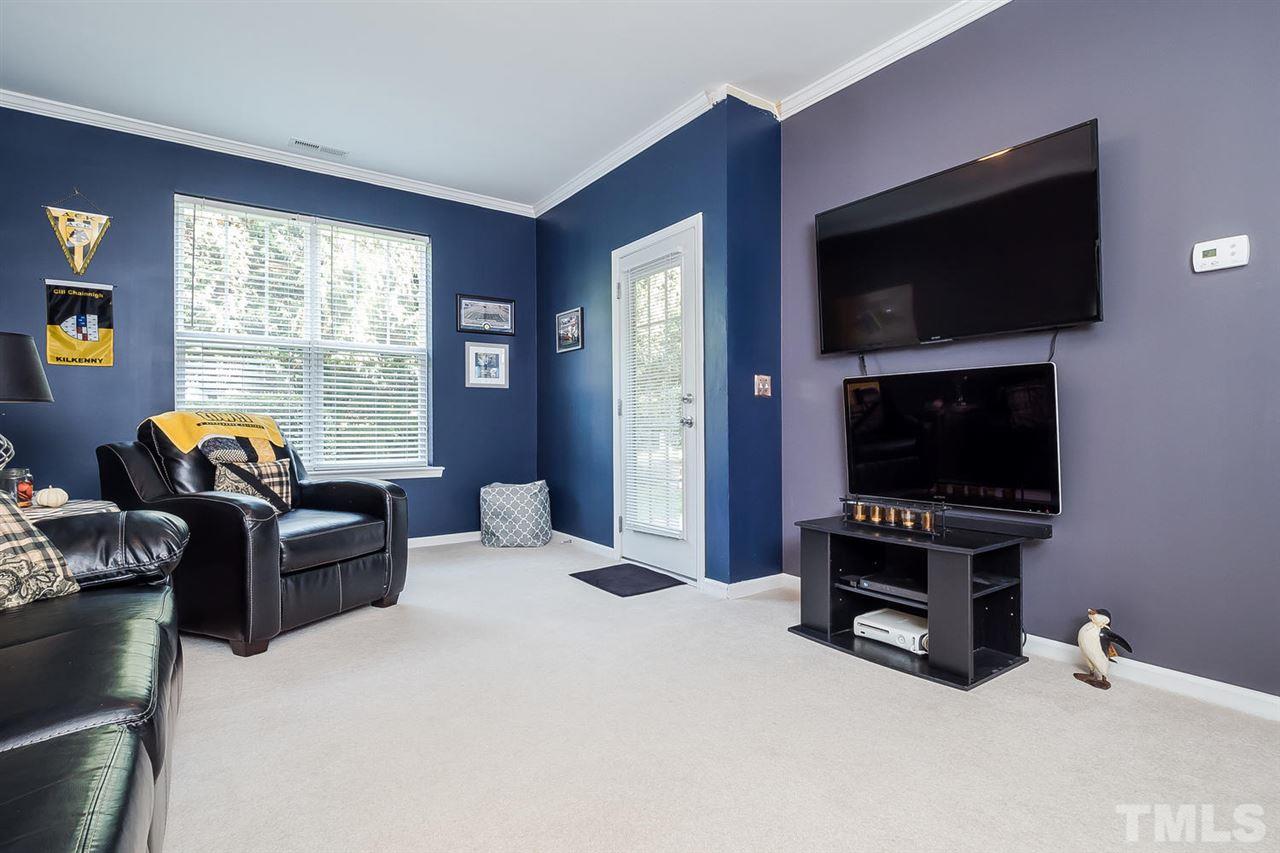 5708 Cameo Glass Way Raleigh, NC 27612 - Photo 11 of 23 a living room with furniture a flat screen tv and a fireplace
