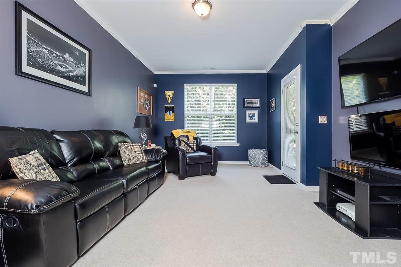 5708 Cameo Glass Way Raleigh, NC 27612 - Photo 12 of 23 a living room with furniture a flat screen tv and a fireplace