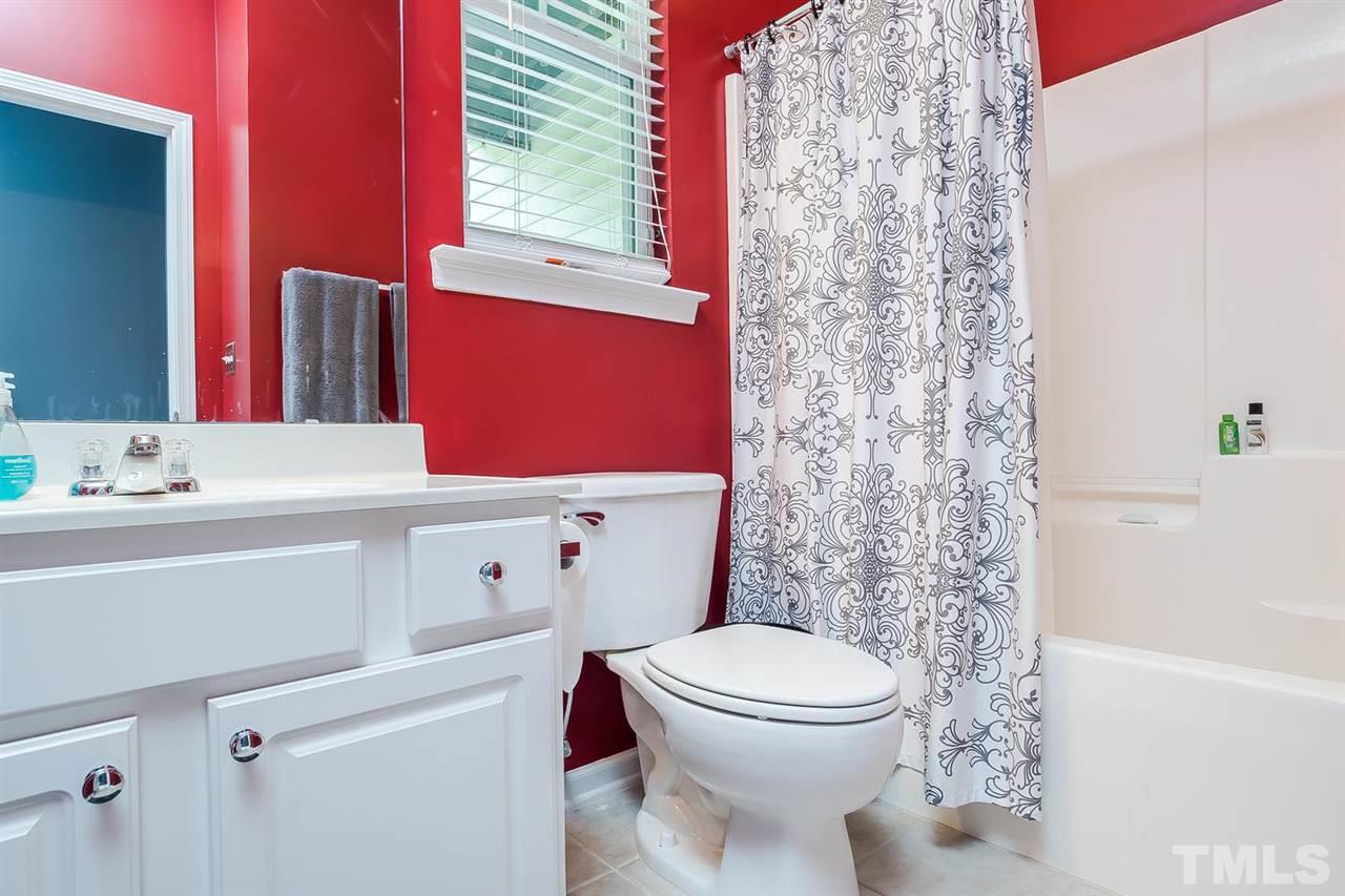 5708 Cameo Glass Way Raleigh, NC 27612 - Photo 13 of 23 a bathroom with a sink a toilet and shower curtain
