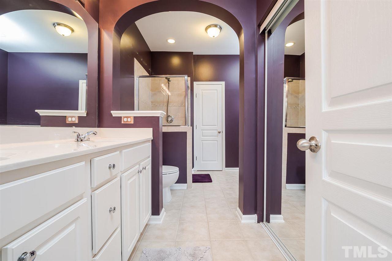 5708 Cameo Glass Way Raleigh, NC 27612 - Photo 15 of 23 a spacious bathroom with a double vanity sink and a mirror