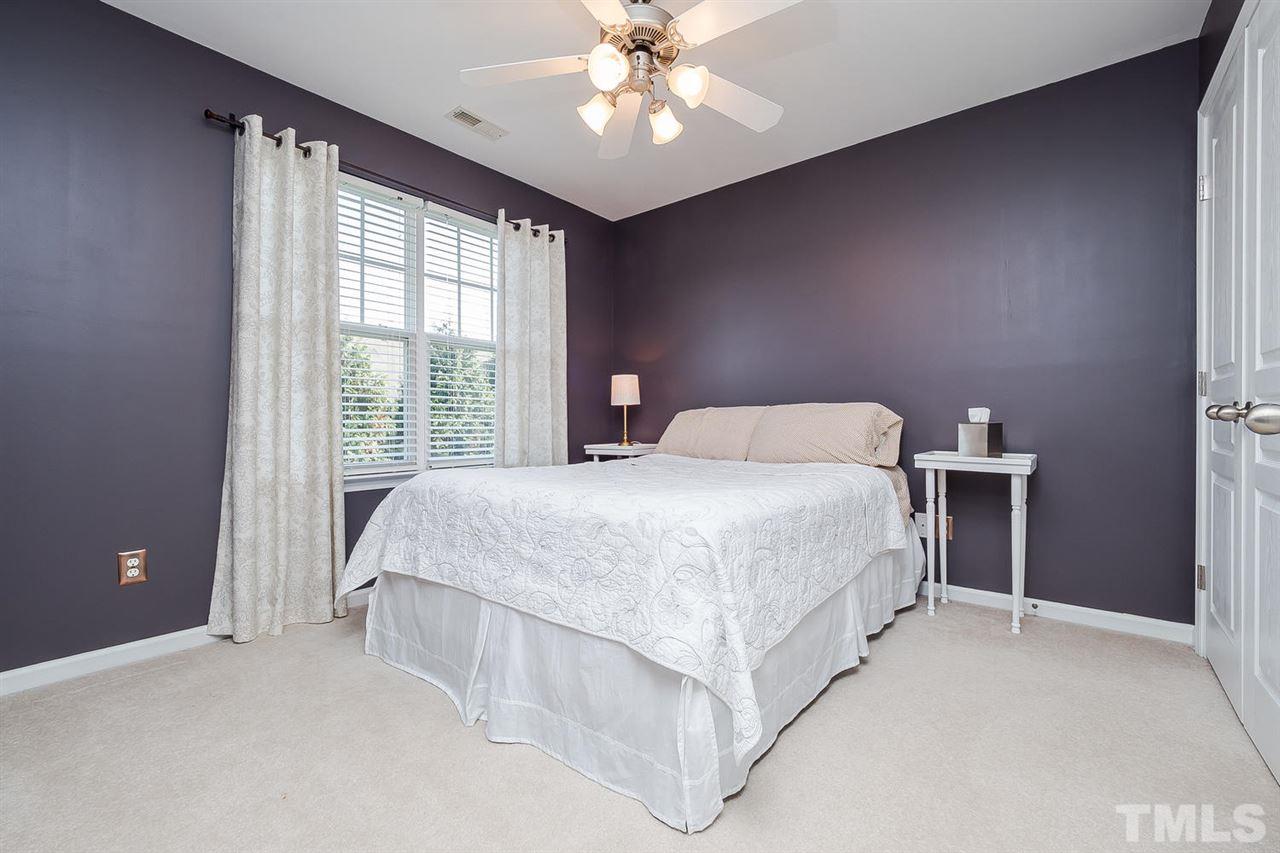 5708 Cameo Glass Way Raleigh, NC 27612 - Photo 18 of 23 a bed room with a bed and a chandelier