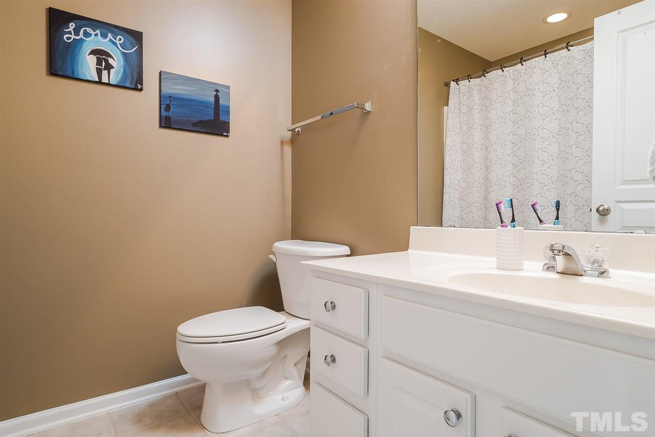 5708 Cameo Glass Way Raleigh, NC 27612 - Photo 19 of 23 a bathroom with a toilet a sink and a mirror