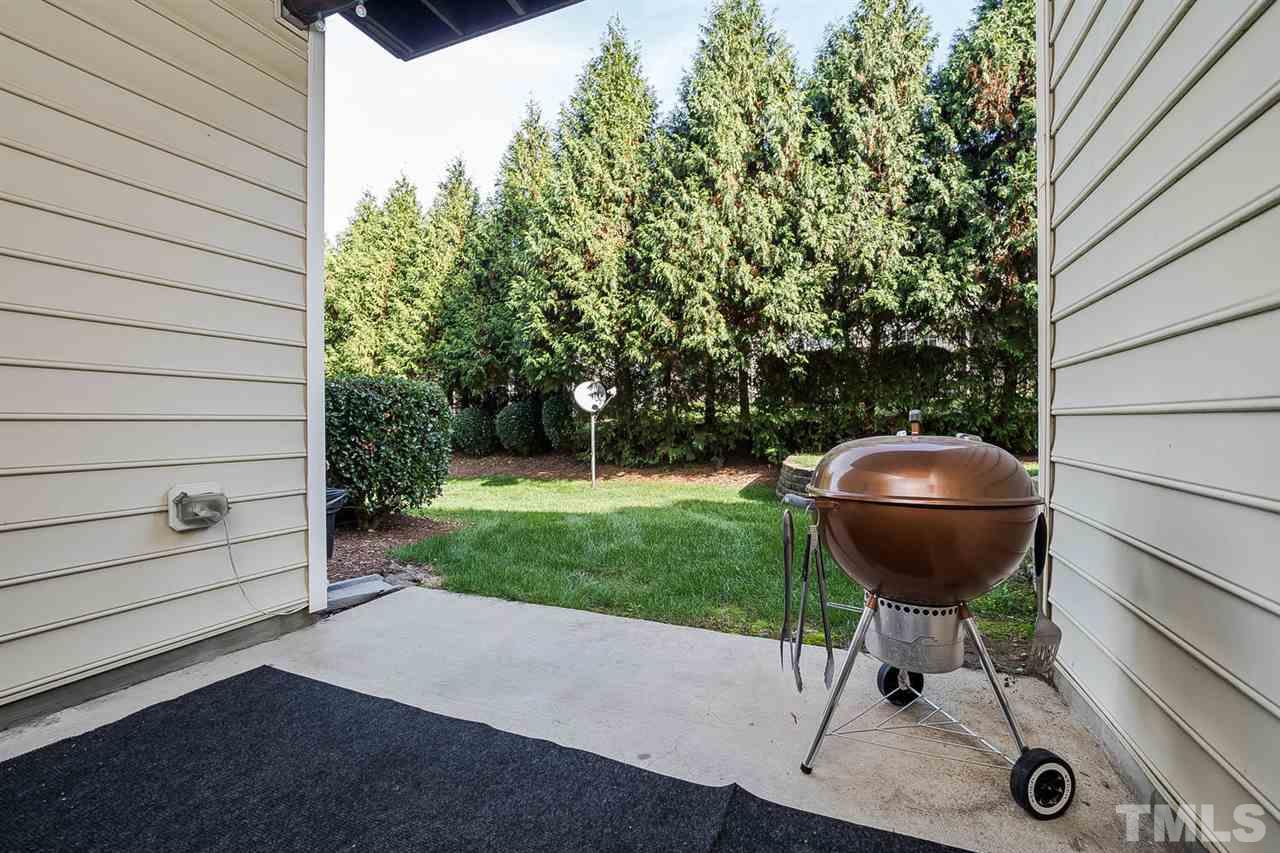 5708 Cameo Glass Way Raleigh, NC 27612 - Photo 21 of 23 a backyard of a house with table and chairs