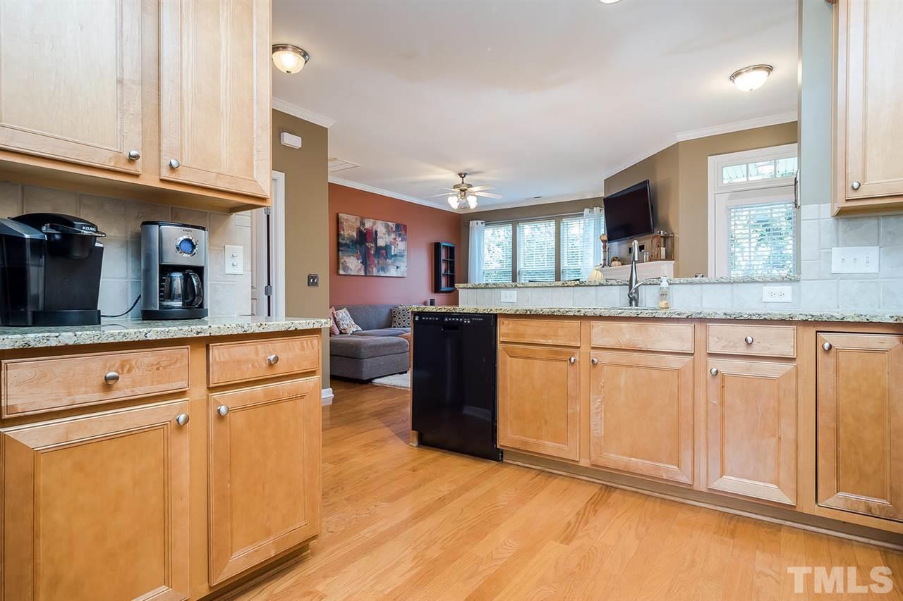 5708 Cameo Glass Way Raleigh, NC 27612 - Photo 5 of 23 a kitchen with granite countertop a sink cabinets and wooden floor