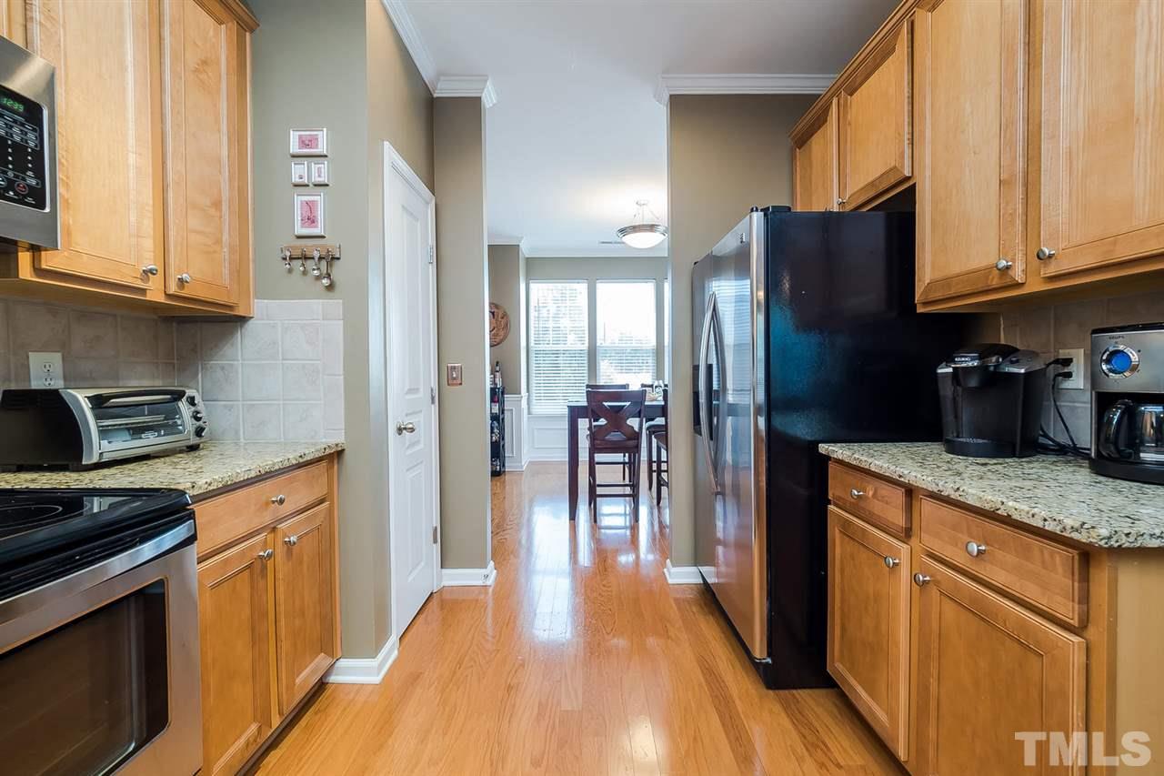 5708 Cameo Glass Way Raleigh, NC 27612 - Photo 6 of 23 a kitchen with stainless steel appliances granite countertop a refrigerator a stove top oven a sink and dishwasher