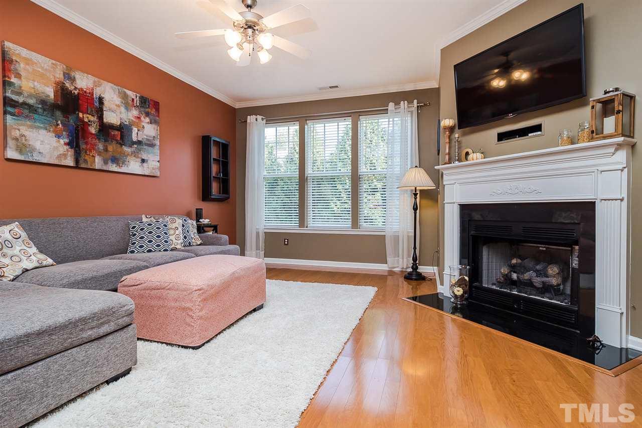 5708 Cameo Glass Way Raleigh, NC 27612 - Photo 7 of 23 a living room with furniture a flat screen tv and a fireplace