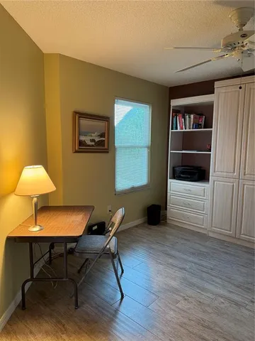 a workspace with furniture window and wooden floor