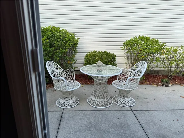 a view of a table and chairs in patio of the porch
