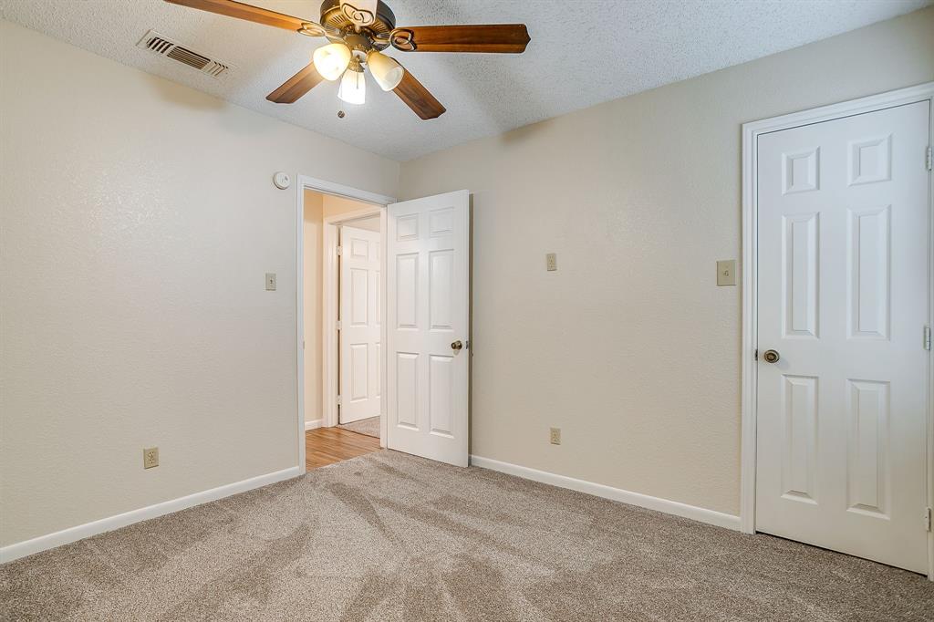 8613 Silver Creek Road White Settlement, TX 76108 - Photo 22 of 40 a view of an empty room and chandelier fan