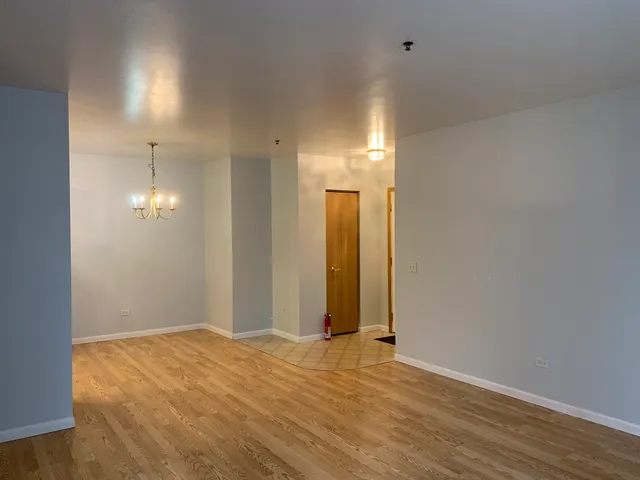 a view of a room with wooden floor and bathroom