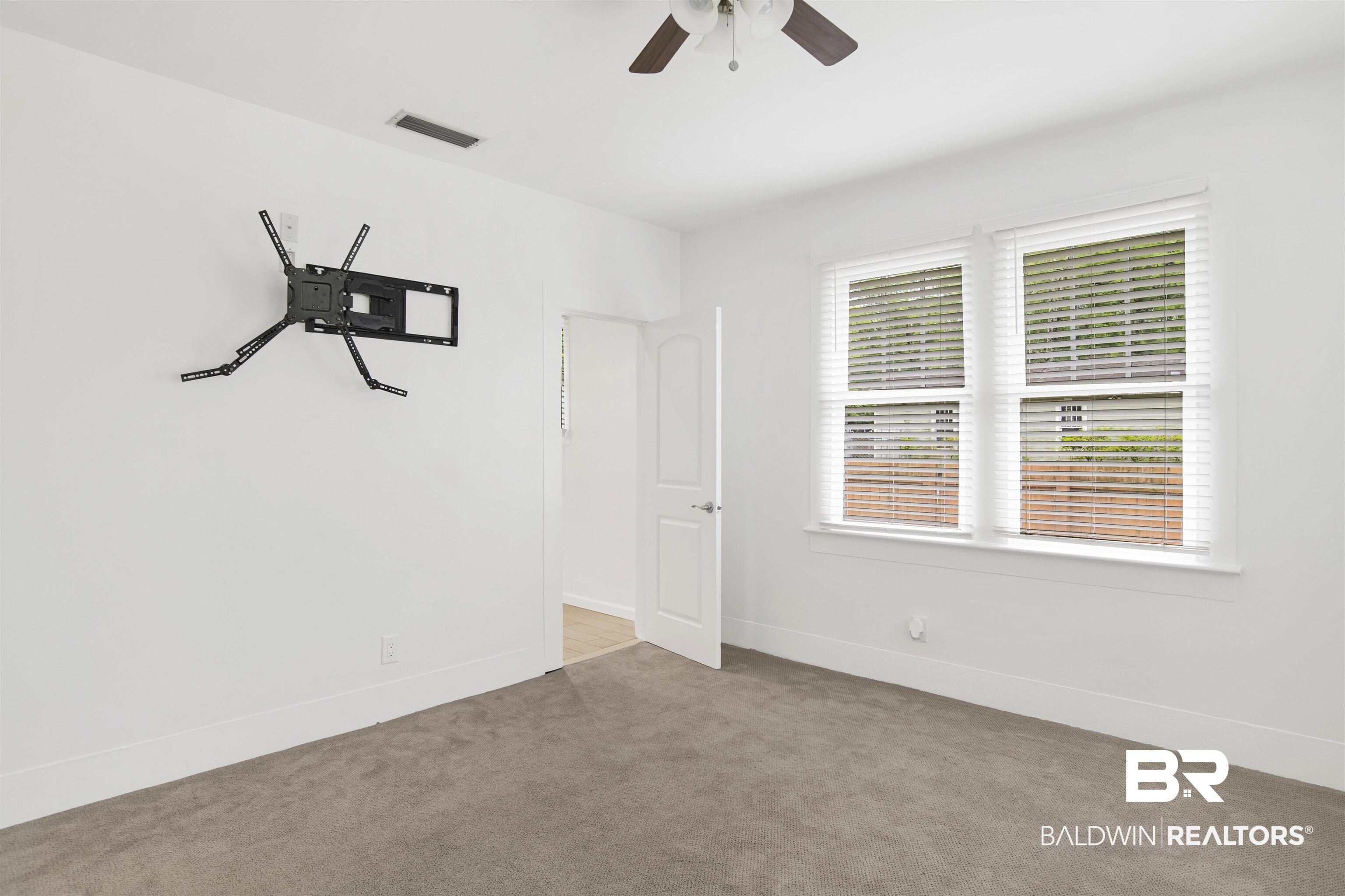 507 Holcombe Avenue Mobile, AL 36606 - Photo 24 of 28 Spare room featuring carpet floors, a ceiling fan, and baseboards