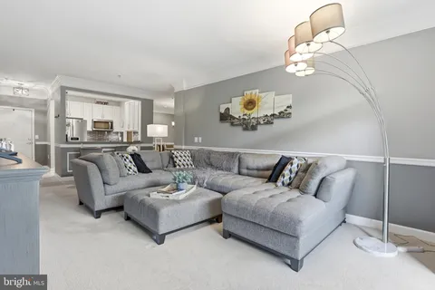 a living room with furniture chandelier and couch