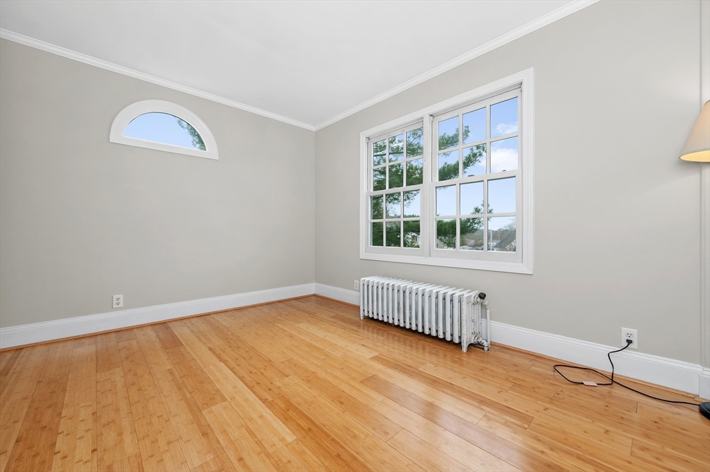 18 Bennett Street, Unit 2 Manchester, MA 01944 - Photo 11 of 21 a view of an empty room with wooden floor and a window