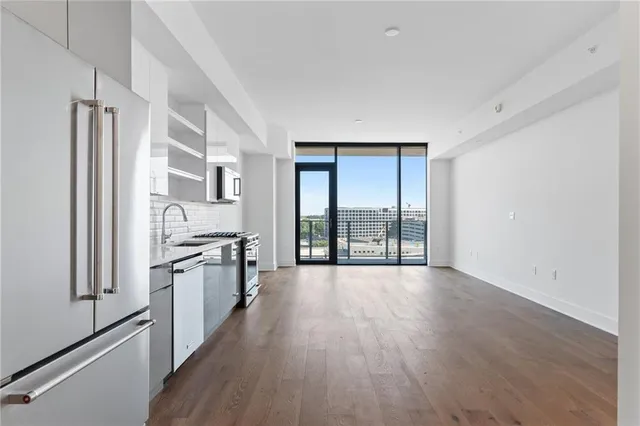 a large kitchen with a large window and stainless steel appliances