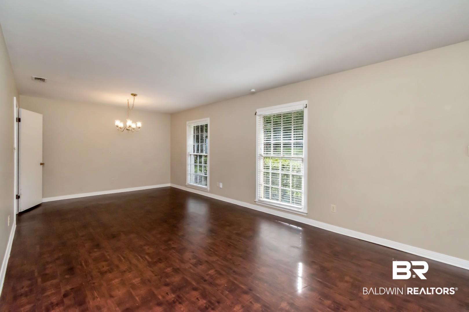324 Judson Drive Mobile, AL 36608 - Photo 5 of 20 Spare room with a chandelier and wood finished floors