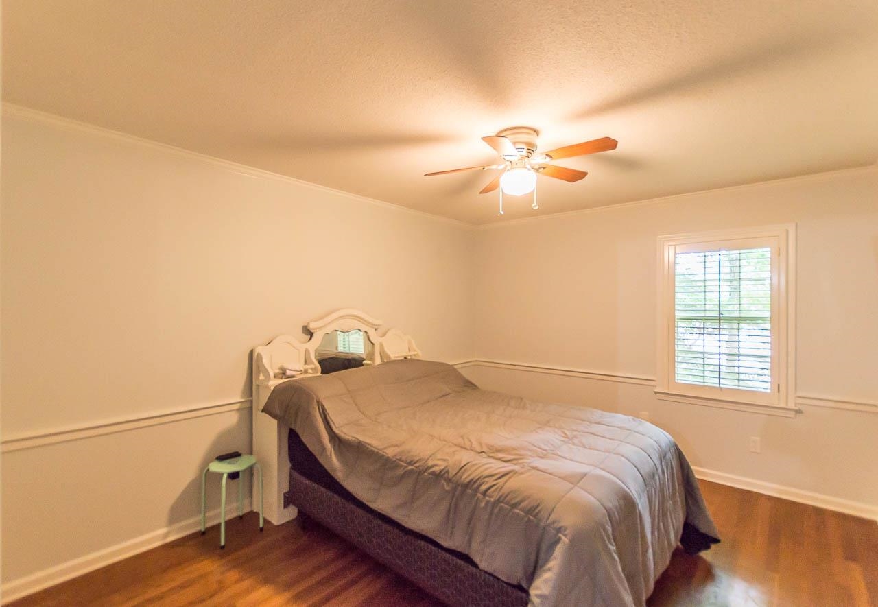 5986 Ivanhoe Road Bartlett, TN 38134 - Photo 14 of 25 a bedroom with a bed and a chandelier