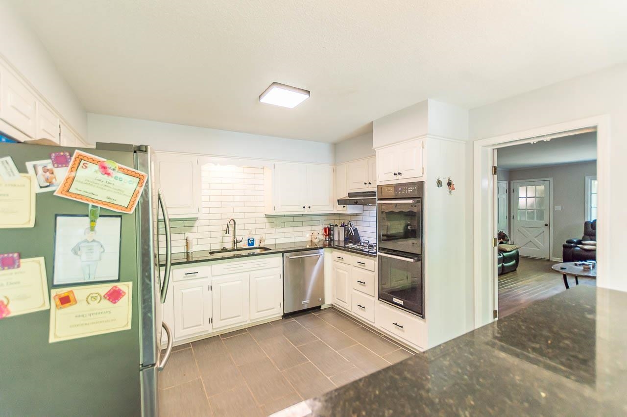 5986 Ivanhoe Road Bartlett, TN 38134 - Photo 8 of 25 a kitchen with stainless steel appliances granite countertop a refrigerator and a stove top oven