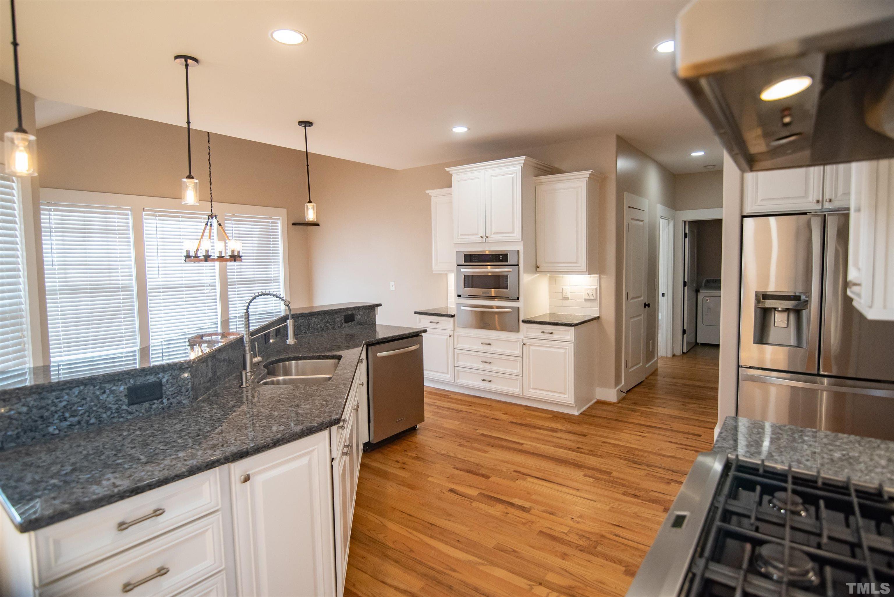 15004 Massimo Dr. Wake Forest, NC 27587 - Photo 10 of 27 a kitchen with stainless steel appliances granite countertop a refrigerator a sink and a stove