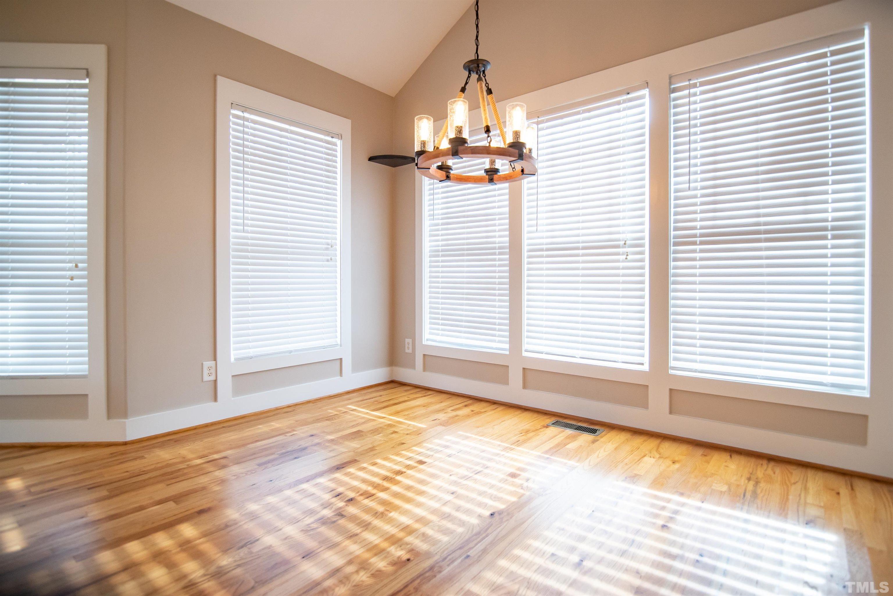 15004 Massimo Dr. Wake Forest, NC 27587 - Photo 12 of 27 an empty room with a windows and chandelier