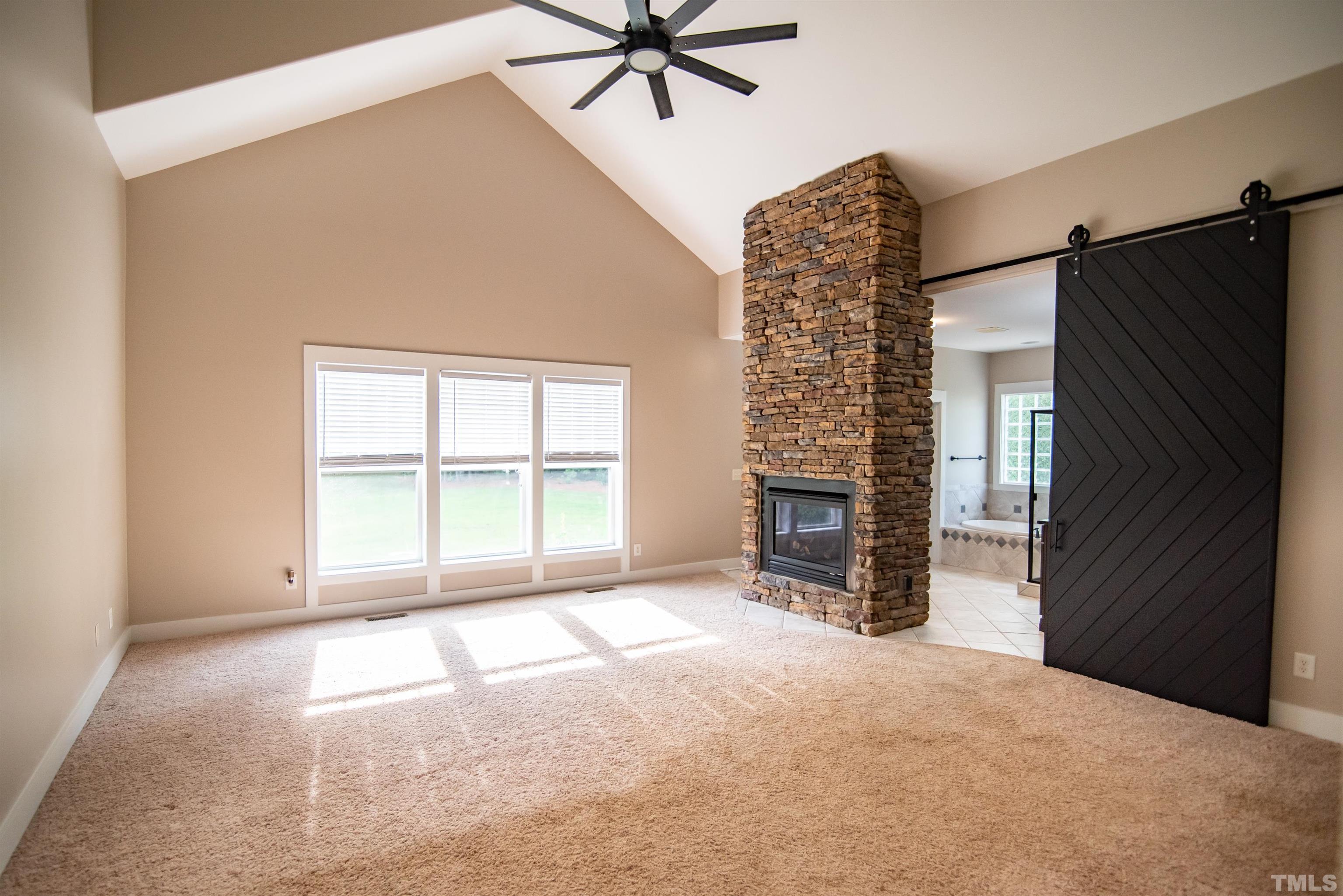 15004 Massimo Dr. Wake Forest, NC 27587 - Photo 13 of 27 an empty room with windows and a ceiling fan