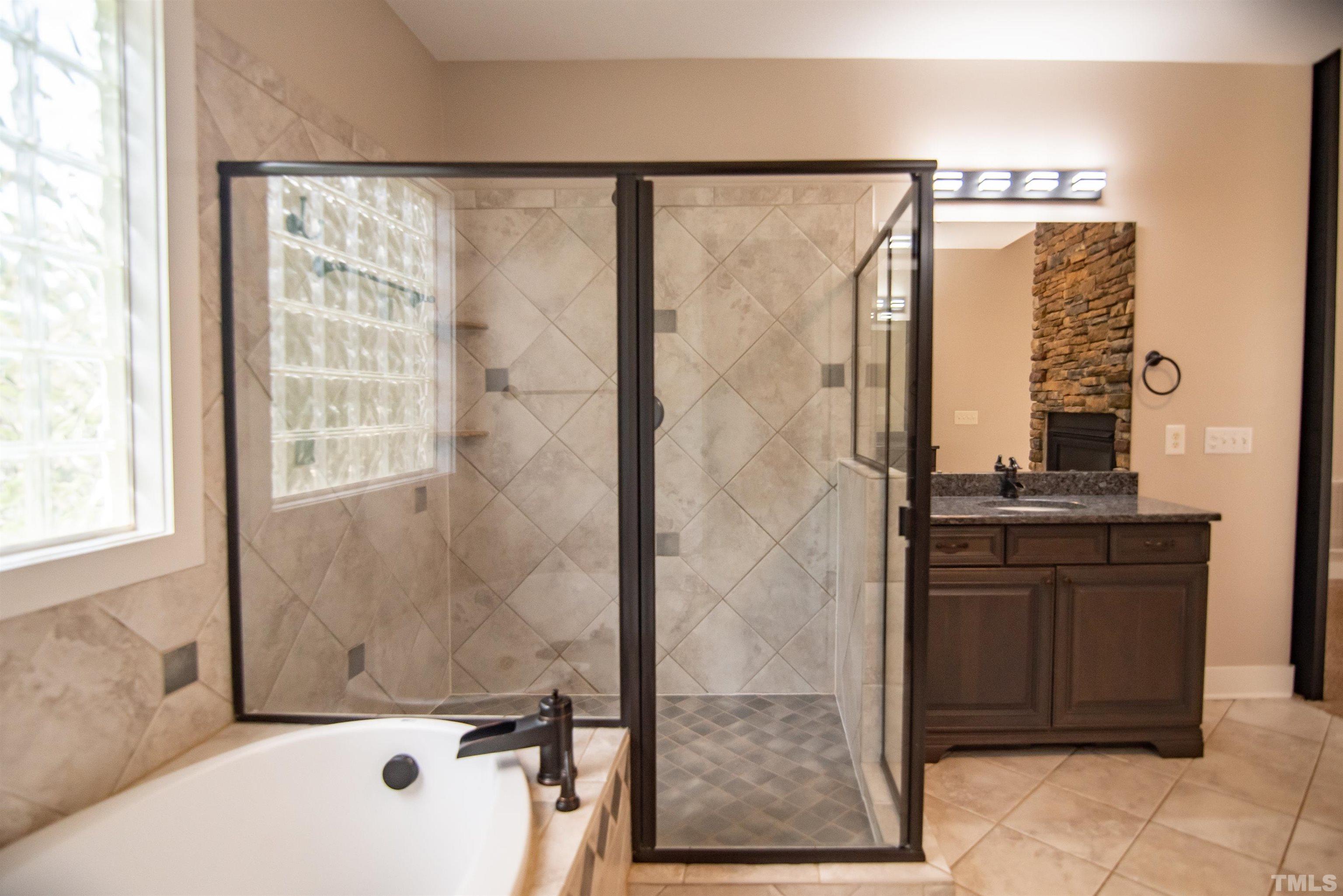 15004 Massimo Dr. Wake Forest, NC 27587 - Photo 15 of 27 a bathroom with a bathtub and a shower