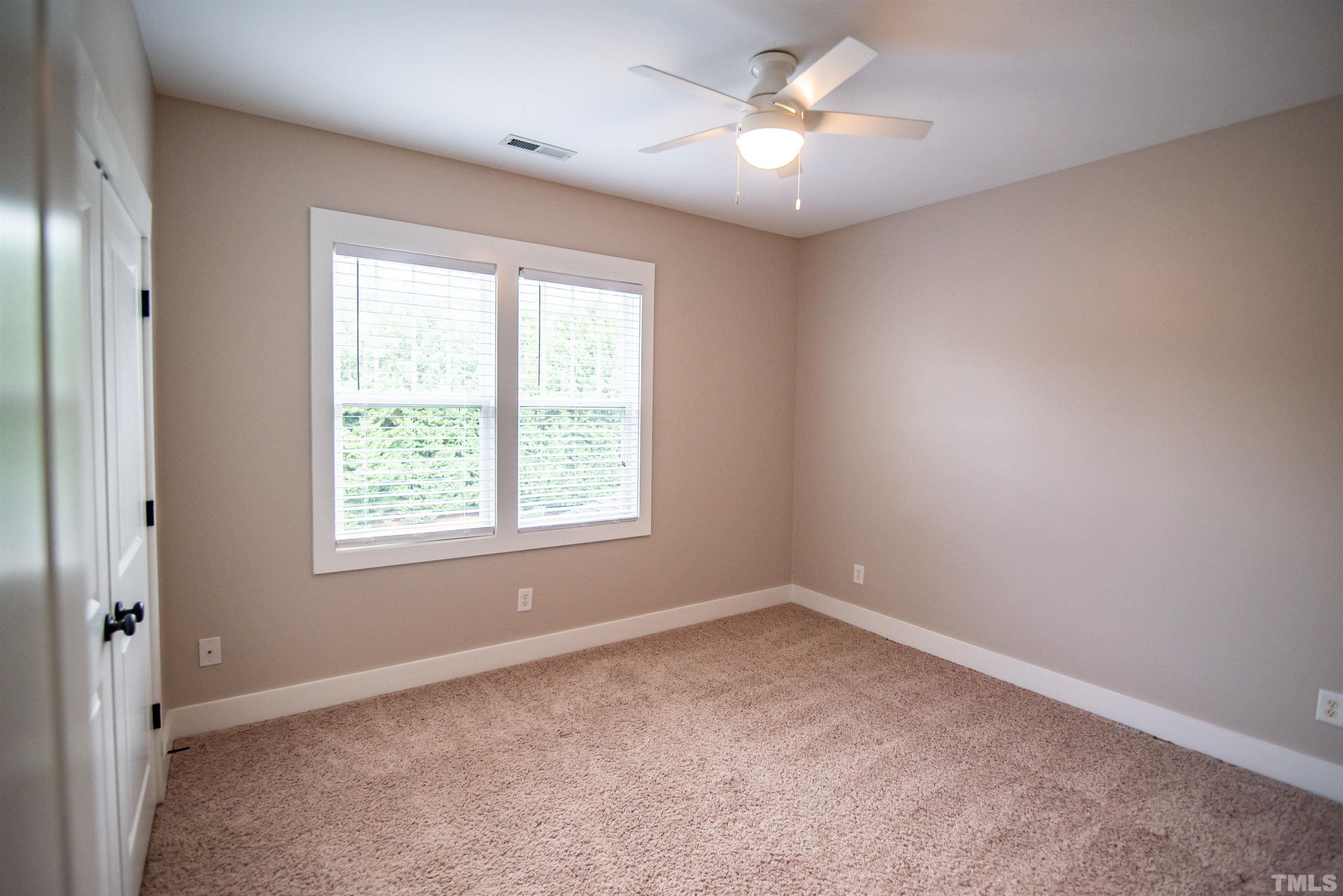 15004 Massimo Dr. Wake Forest, NC 27587 - Photo 16 of 27 an empty room with a window and a fan