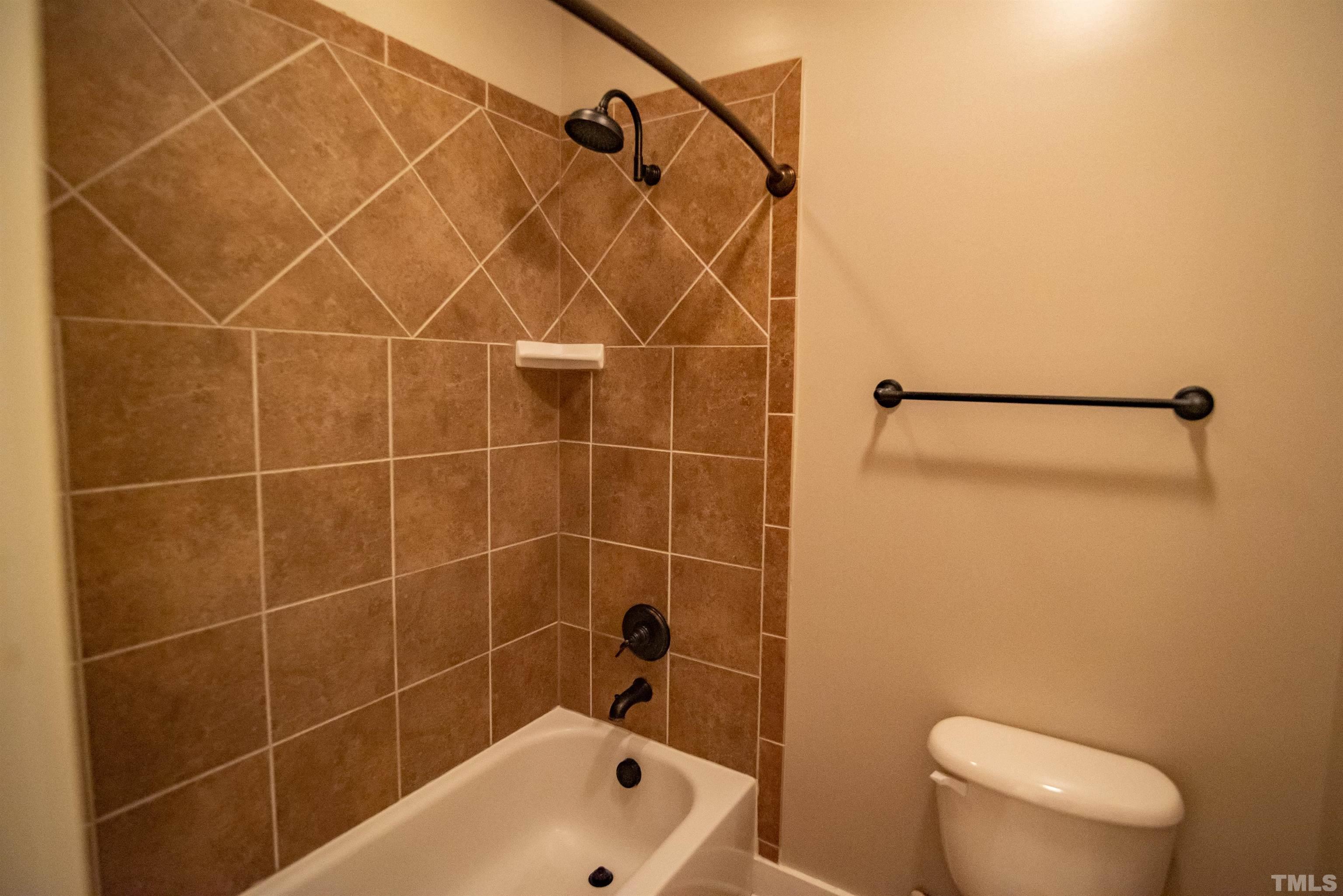 15004 Massimo Dr. Wake Forest, NC 27587 - Photo 18 of 27 a bathroom with a toilet and a shower