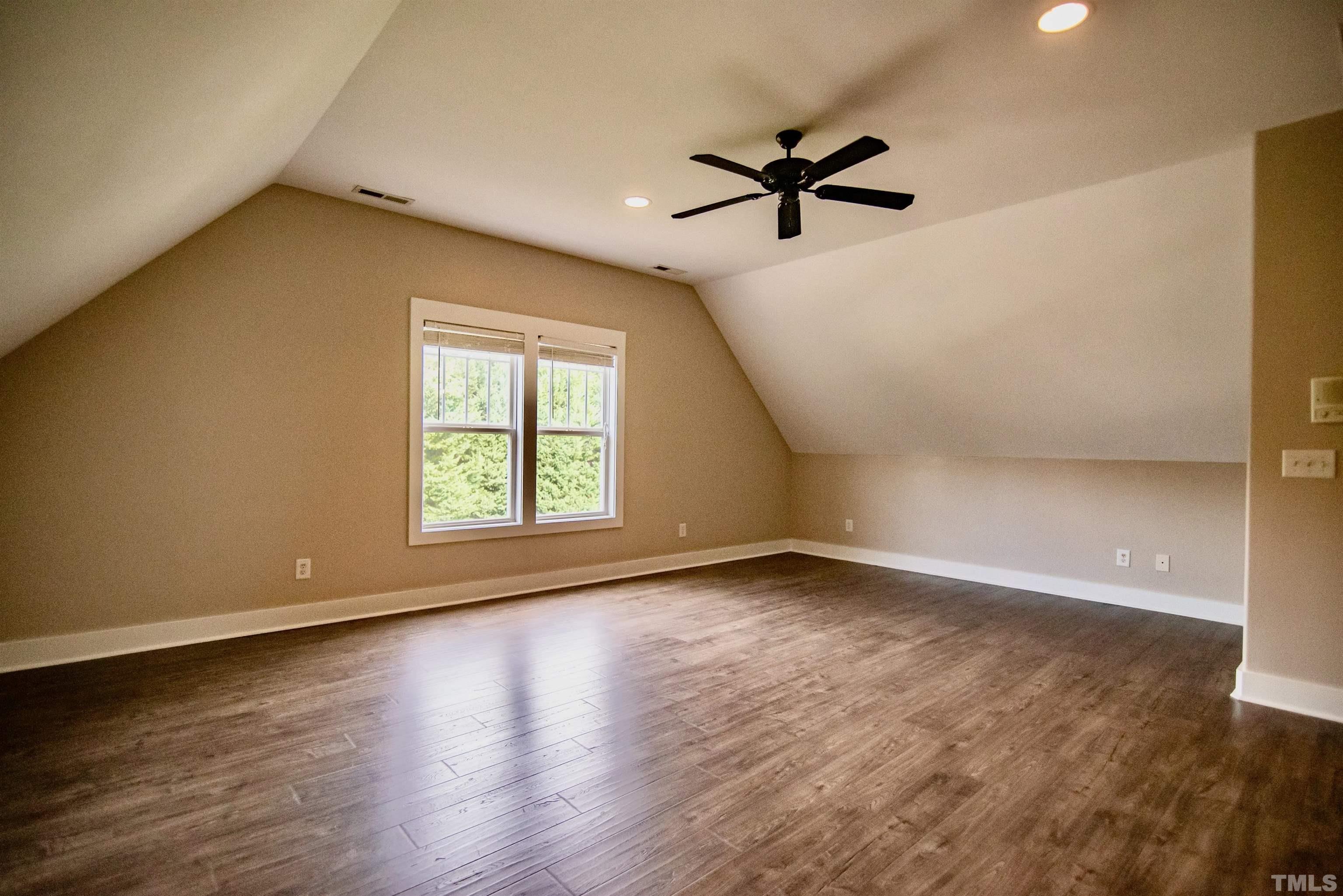 15004 Massimo Dr. Wake Forest, NC 27587 - Photo 21 of 27 a view of empty room with wooden floor and fan