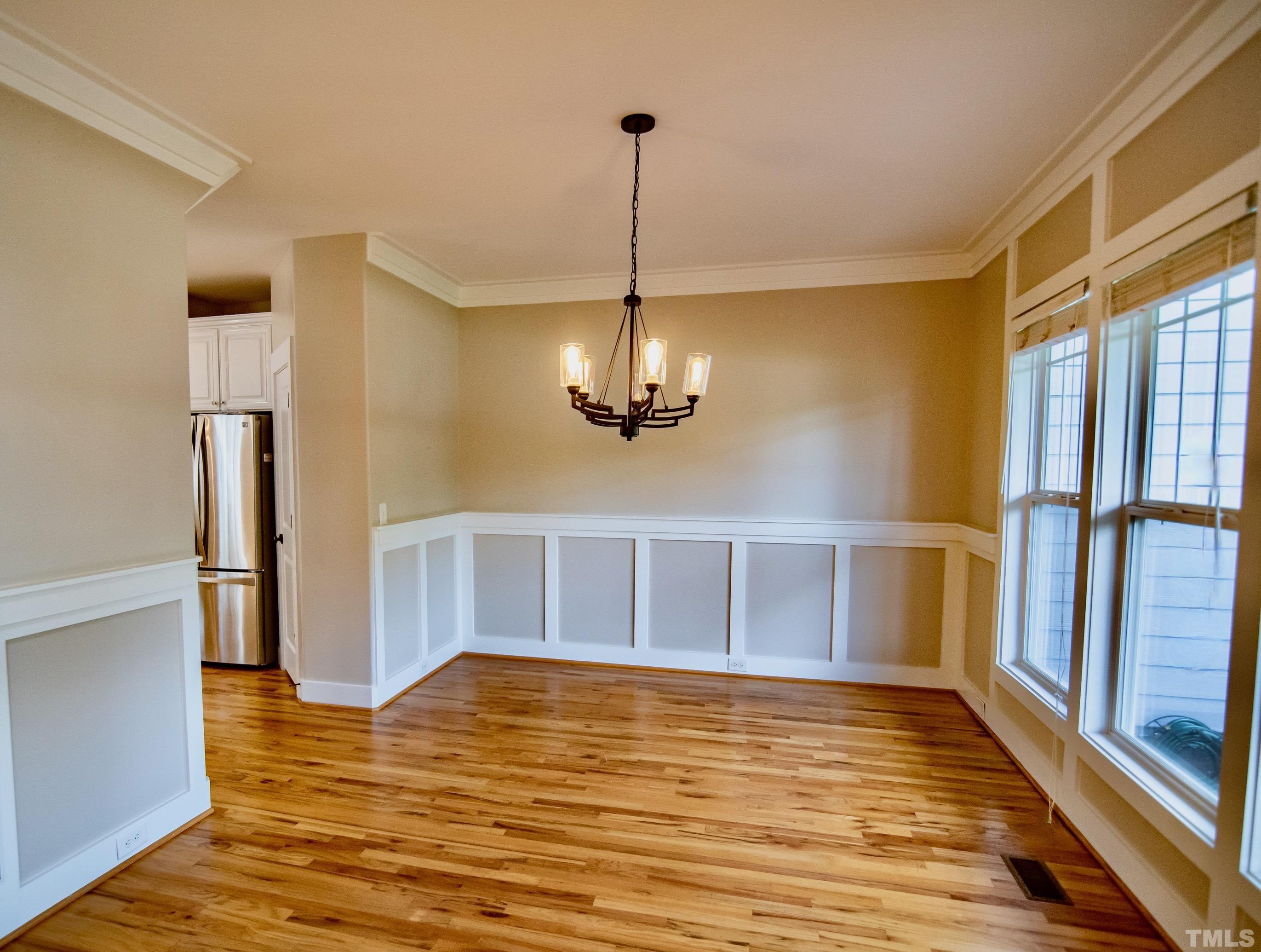 15004 Massimo Dr. Wake Forest, NC 27587 - Photo 4 of 27 a view of a room with wooden floor and a ceiling fan