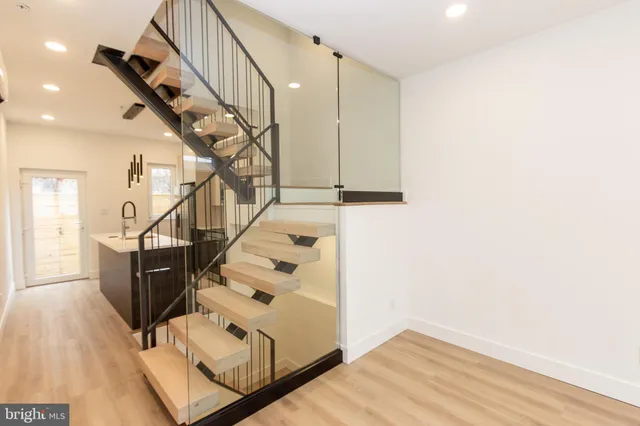 a view of entryway and hall with wooden floor