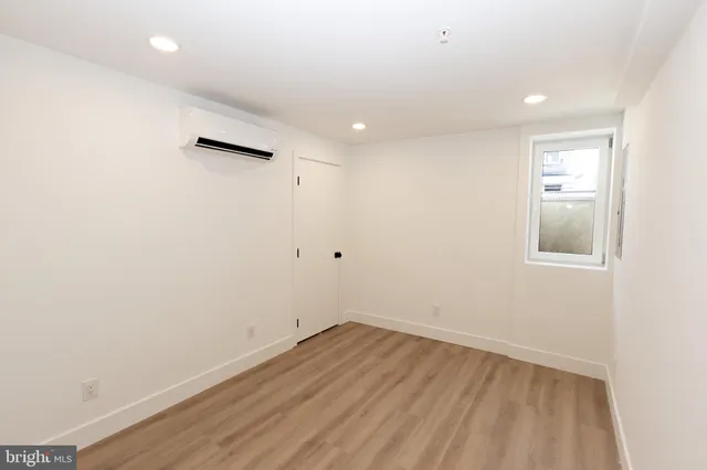 a view of a room with wooden floor and white walls