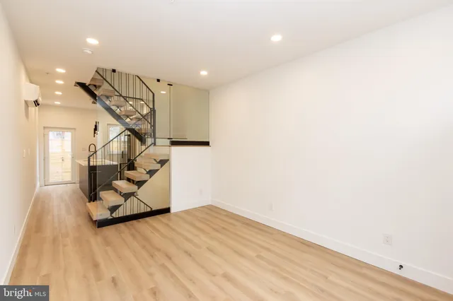 a view of entryway and hall with wooden floor