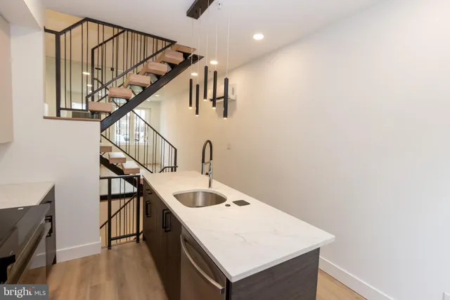 a view of staircase and kitchen with sink