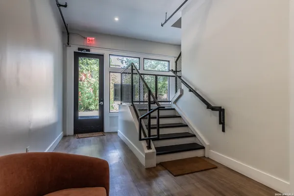 a view of entryway and hall with wooden floor