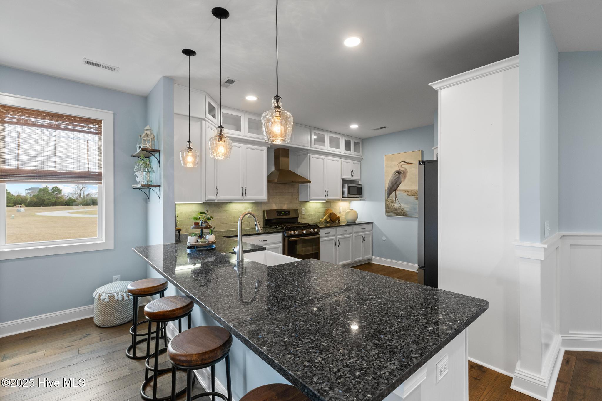 817 Sweetgrass Street Holly Ridge, NC 28445 - Photo 13 of 72 KITCHEN, GRANITE COUNTERTOPS. WALK-IN PANTRY. PROPANE RANGE.