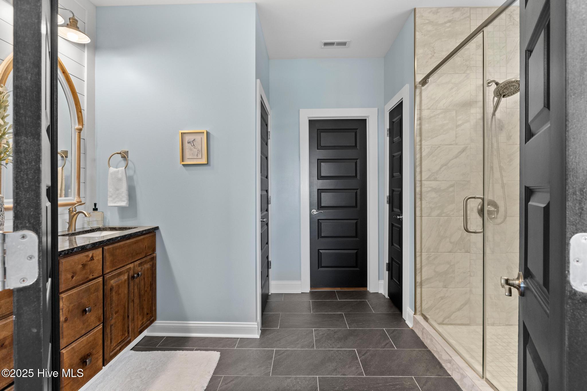 817 Sweetgrass Street Holly Ridge, NC 28445 - Photo 38 of 72 PRIMARY BATH. TILED SHOWER WITH BENCH AND WALK-IN CLOSET.