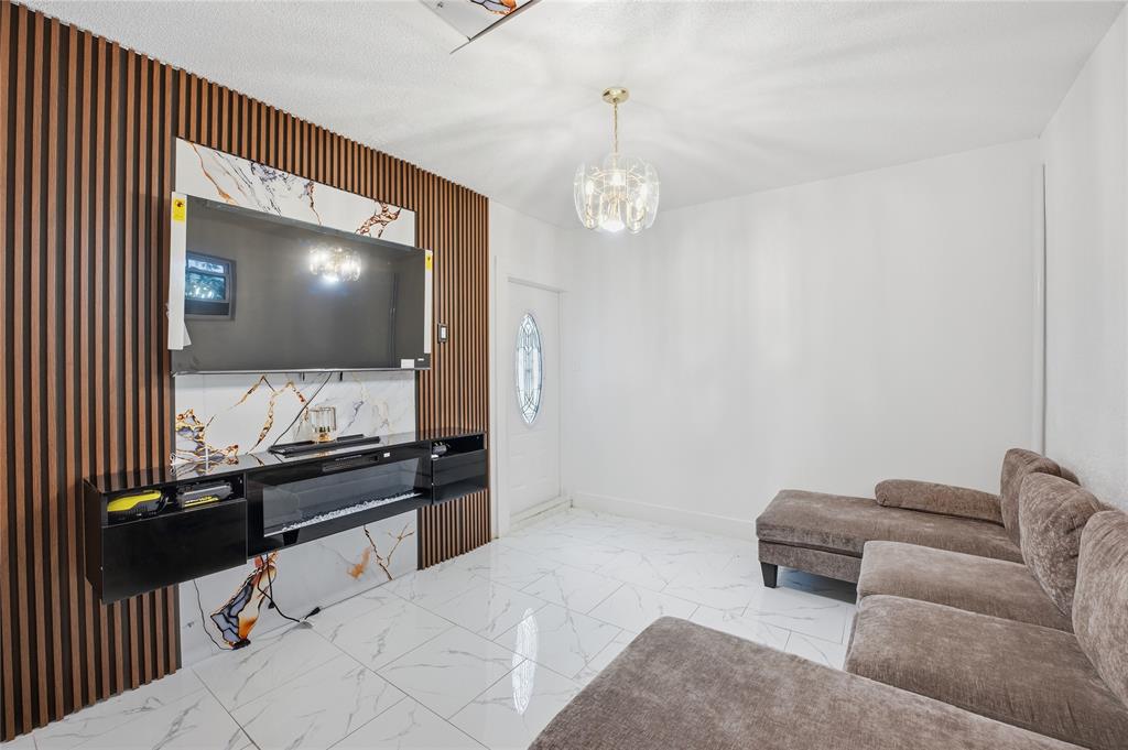 6599 Northwest 1st Street Margate, FL 33063 - Photo 11 of 43 a living room with furniture and a flat screen tv