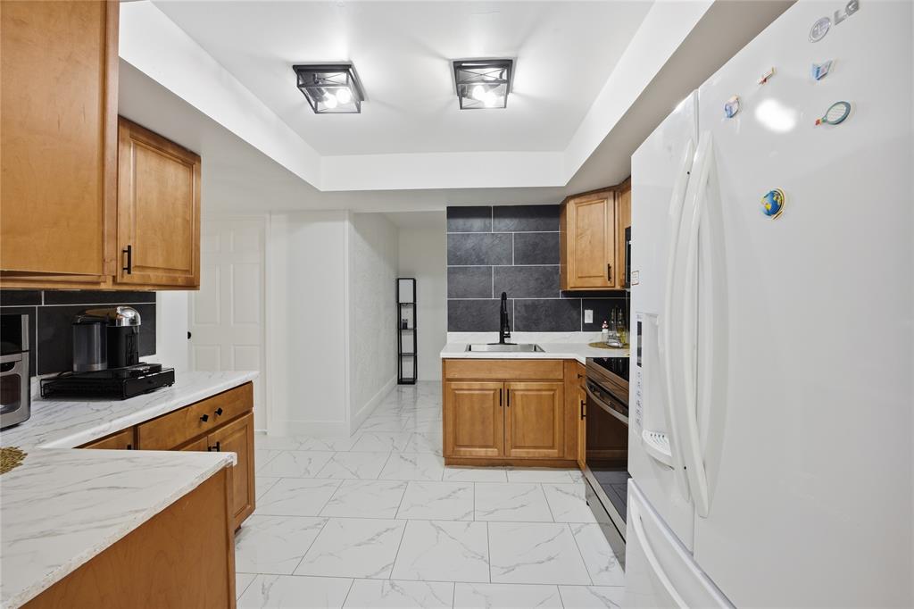 6599 Northwest 1st Street Margate, FL 33063 - Photo 12 of 43 a kitchen with stainless steel appliances granite countertop a sink stove and refrigerator