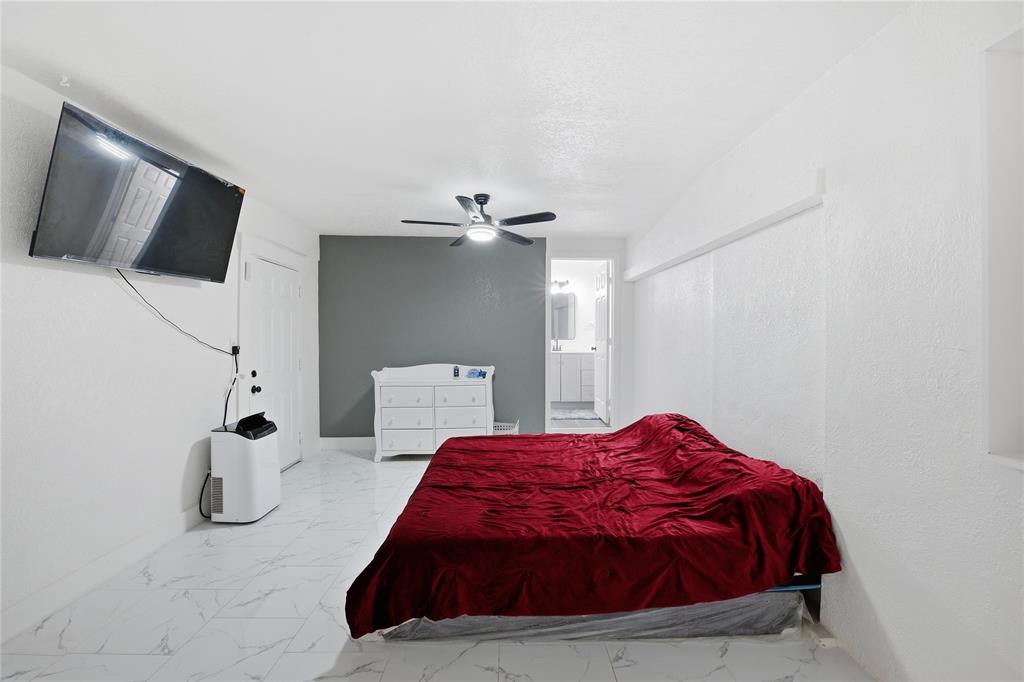 6599 Northwest 1st Street Margate, FL 33063 - Photo 17 of 43 a bedroom with a bed and flat screen tv