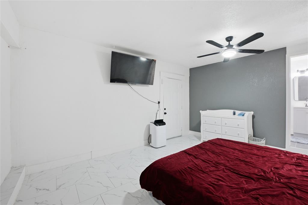 6599 Northwest 1st Street Margate, FL 33063 - Photo 18 of 43 a bedroom with a bed and a flat screen tv