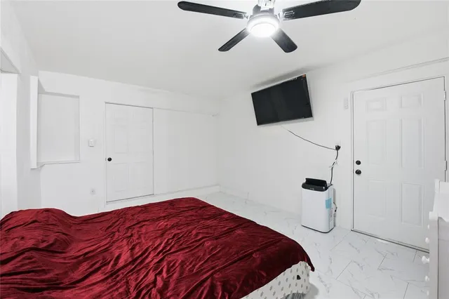 a bedroom with a bed and a flat screen tv